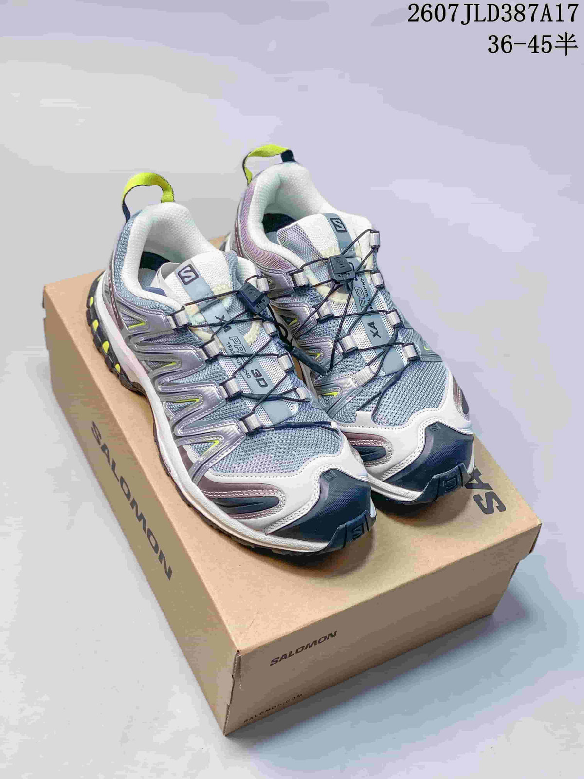 Pair of Salomon XA PRO 3D trail running shoes in grey, white, purple and lime, displayed on a Salomon shoebox.