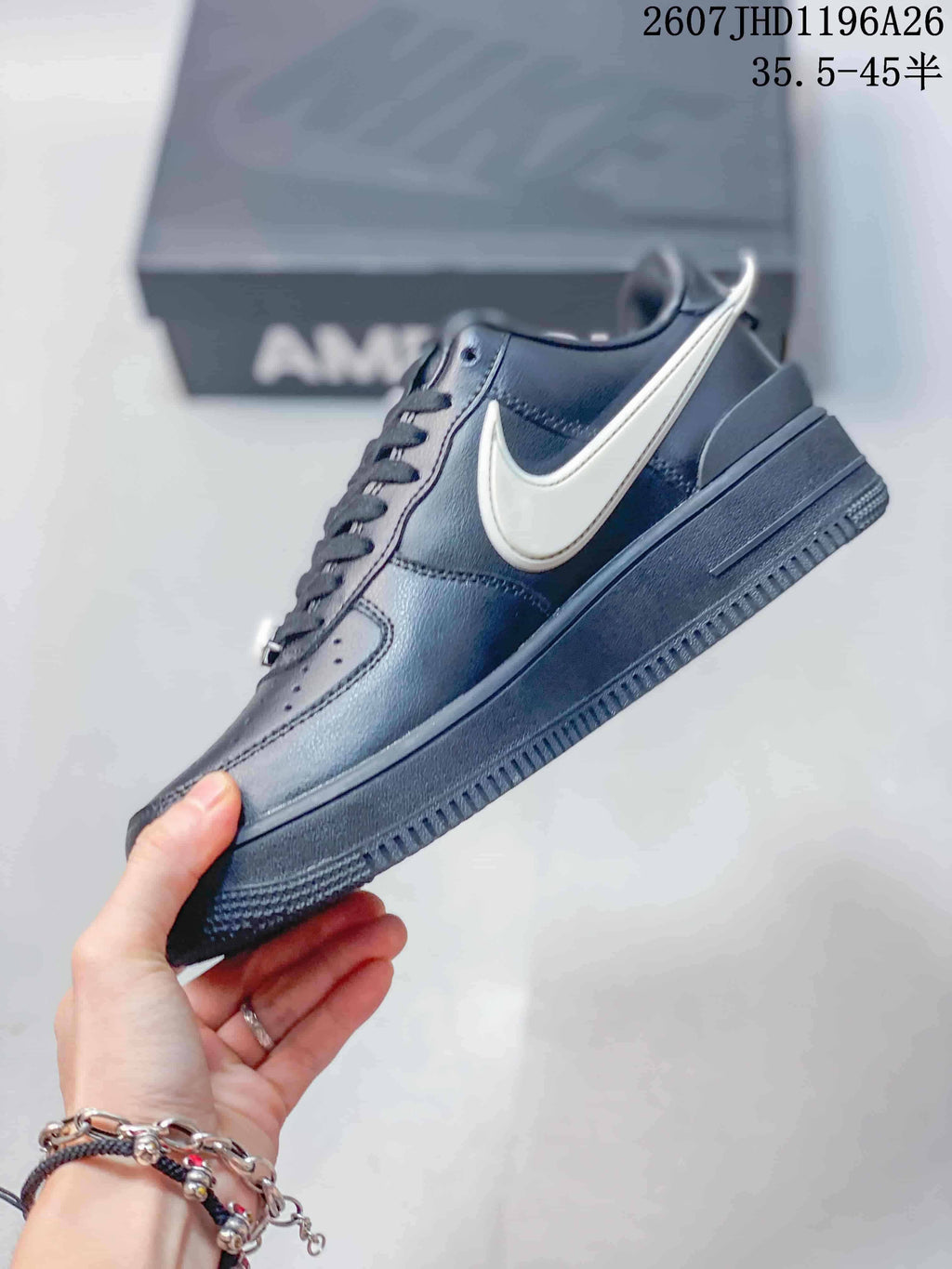 Side profile showing the black upper, contrasting white Swoosh, and low-top sole.