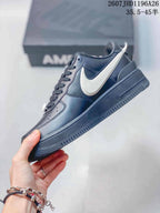 Side profile showing the black upper, contrasting white Swoosh, and low-top sole.