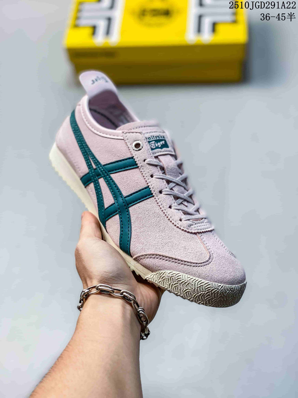 Angled side view of the pink and teal sneaker showing the layered side stripes, lace-up design and cream rubber outsole.
