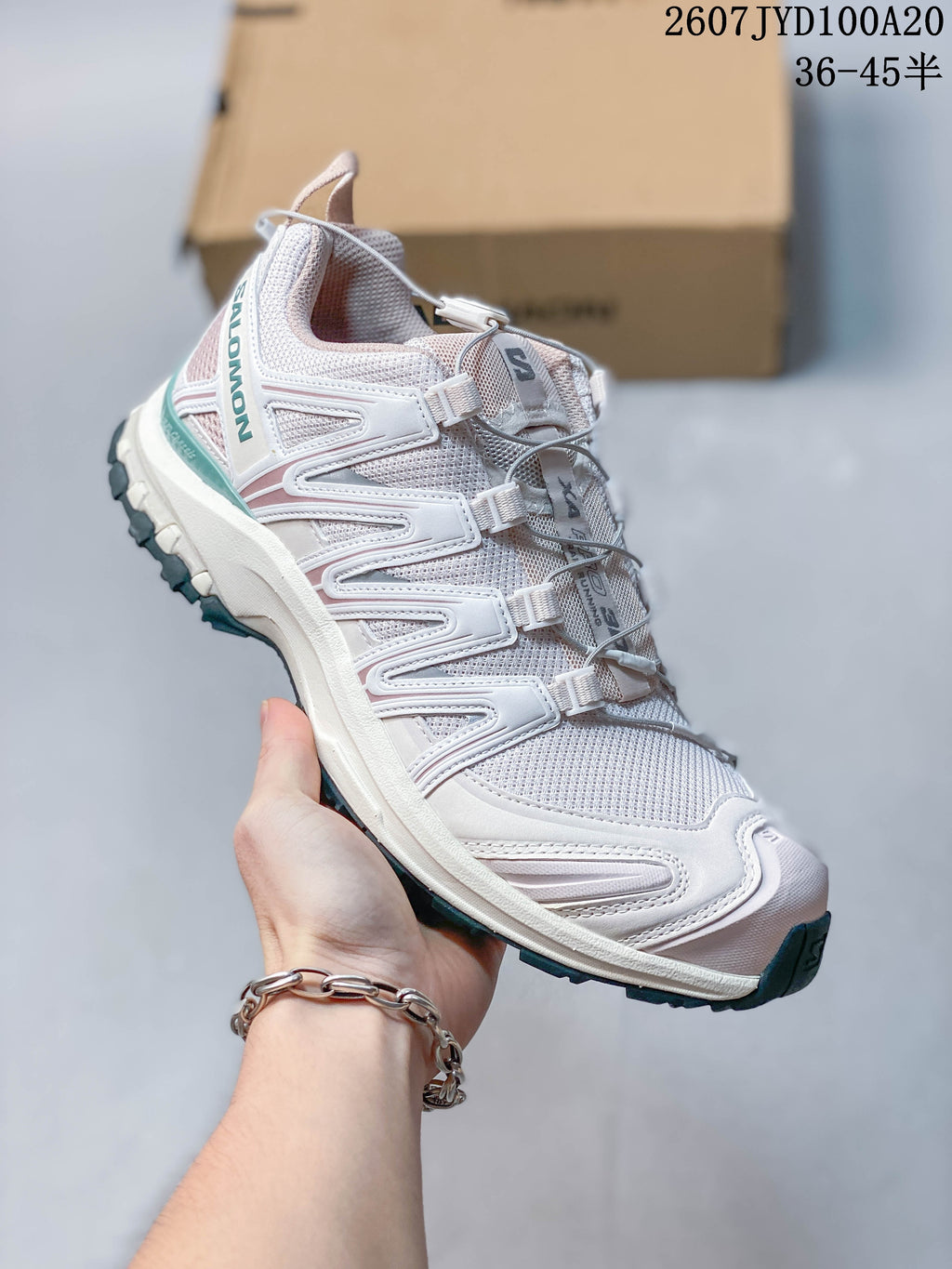 Angled side view of the white Salomon XA PRO 3D sneaker showing the mesh upper, layered side structure and lugged outsole.