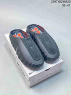 Black Nike Mind 001 slides displayed on a product box.