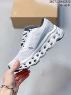 Side view of the white and gray running shoe showing the On side logo, textured upper, and segmented midsole openings; the image displays style code 2607JGD492A22 and size range 36–46.