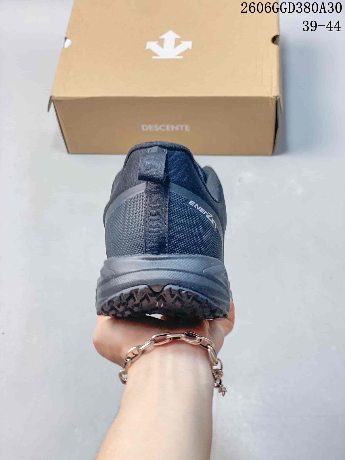 Rear view of a dark gray Descente shoe with heel pull tab