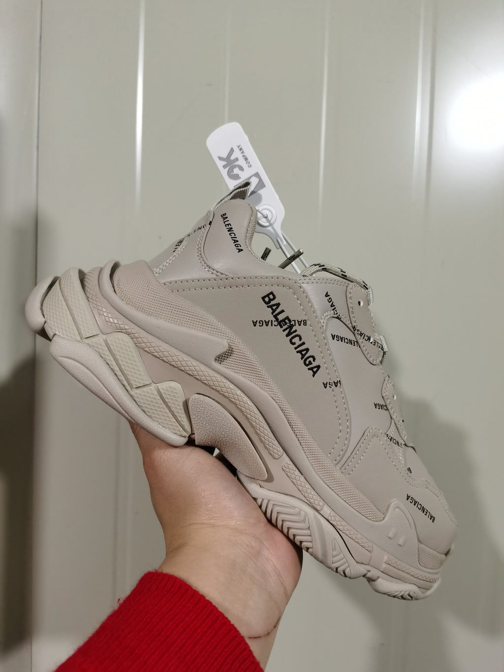 Side view of the khaki Balenciaga Triple S sneaker highlighting the layered upper, branding, and multi-section outsole.