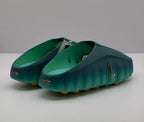 Rear angled view showing the open-back design, green interior, and heel branding details.
