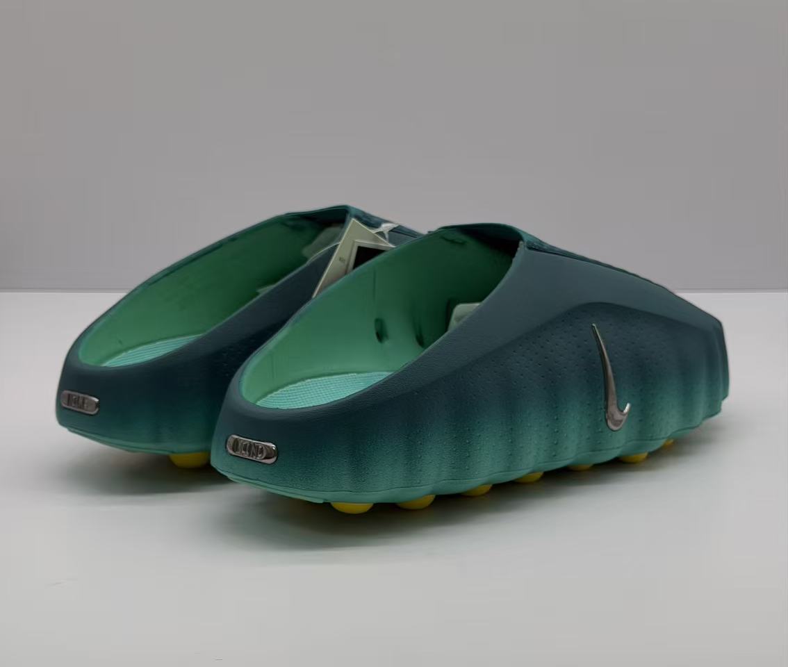 Rear angled view showing the open-back design, green interior, and heel branding details.