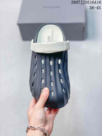 Front view of the navy sandal showing the white strap, covered toe, and perforated upper.