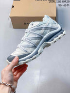 Side view showing the layered panels and outsole of a Salomon XT-Quest ATHR sneaker.