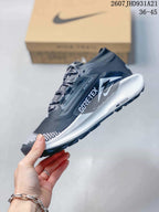 Side profile showing the dark mesh upper, Nike Trail branding, GORE-TEX marking, white midsole, and black outsole.