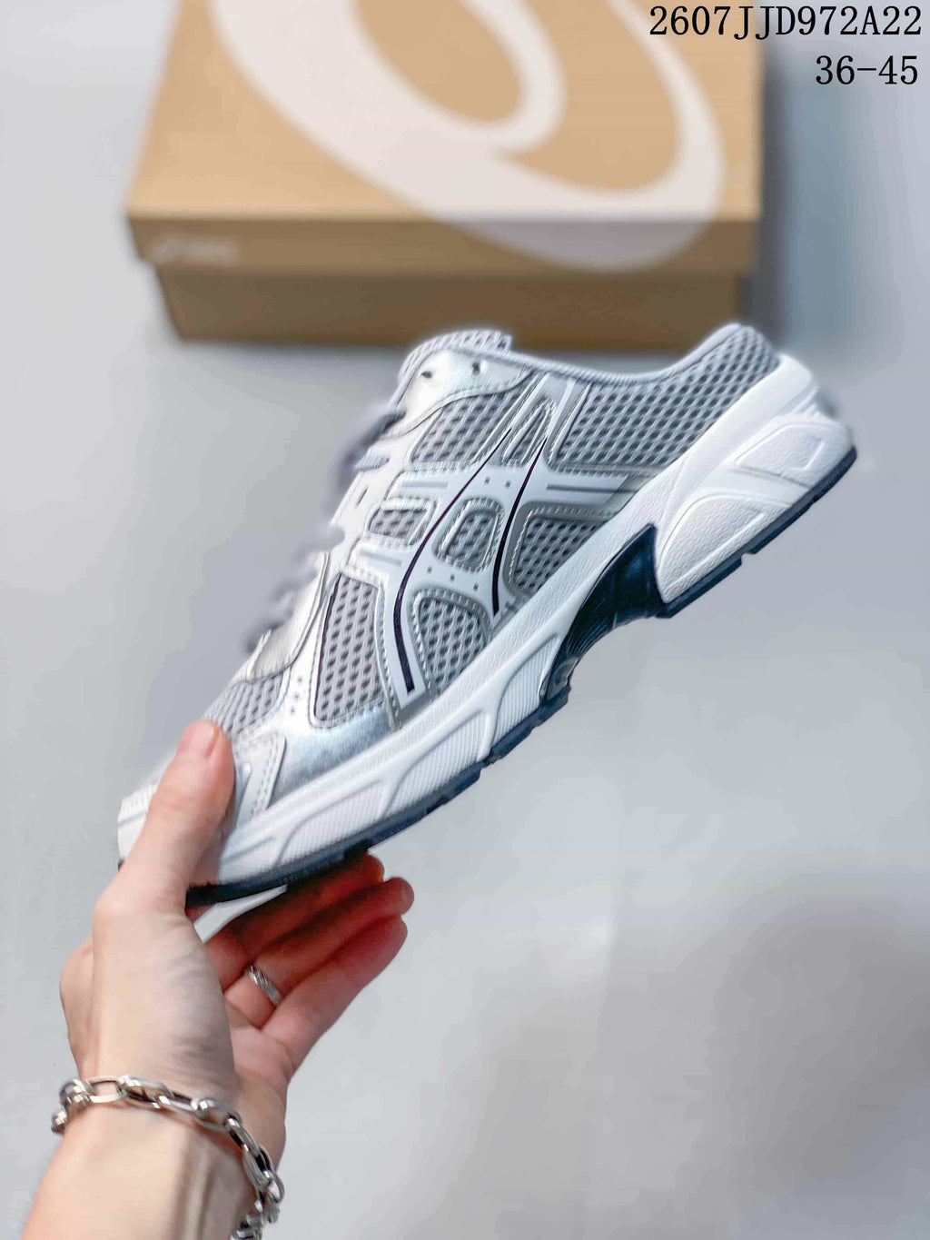 Side profile highlighting the mesh-style panels, layered ASICS side detailing and structured sole.
