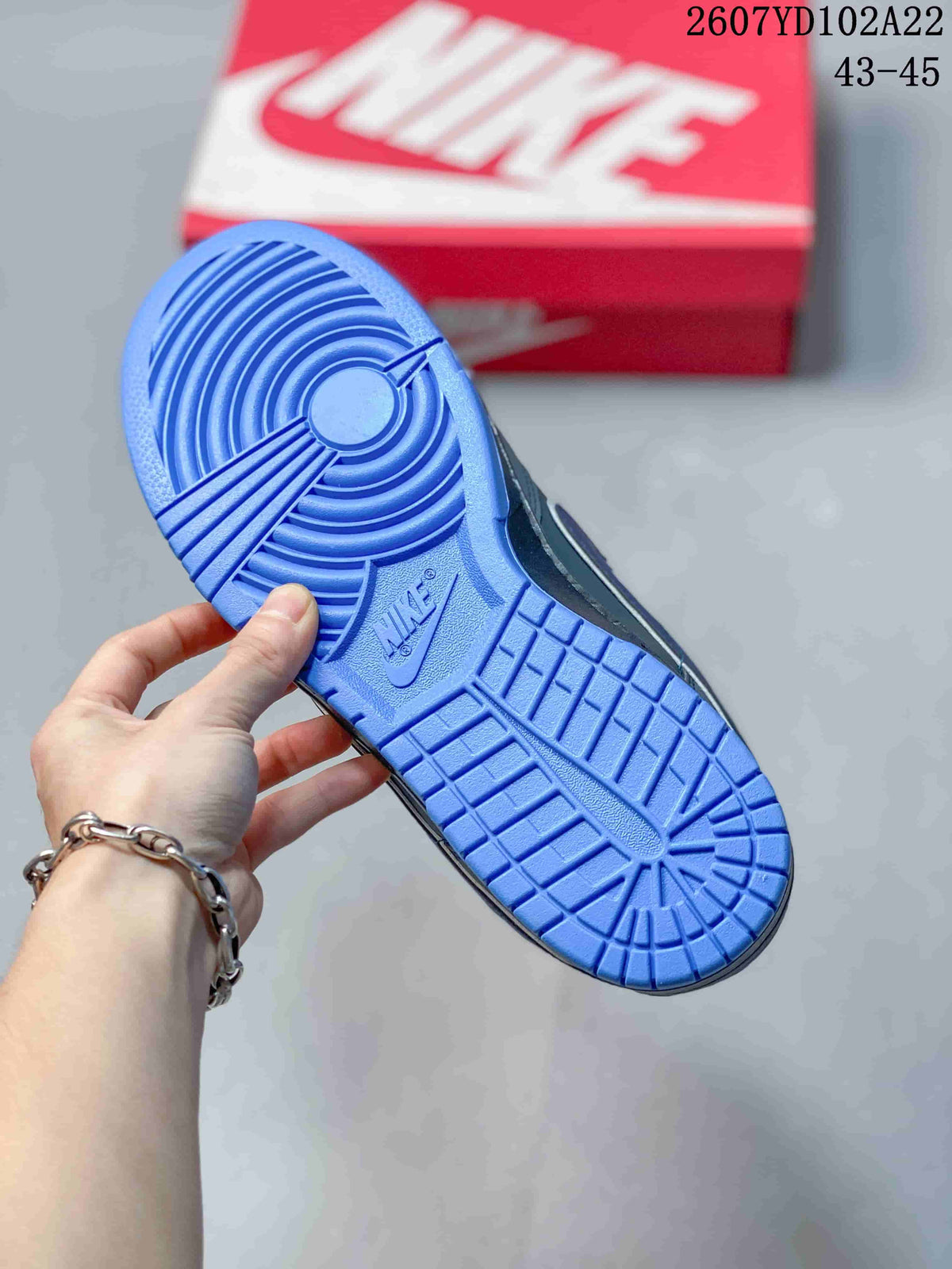 Close-up of the blue rubber outsole showing its circular traction pattern and branding.