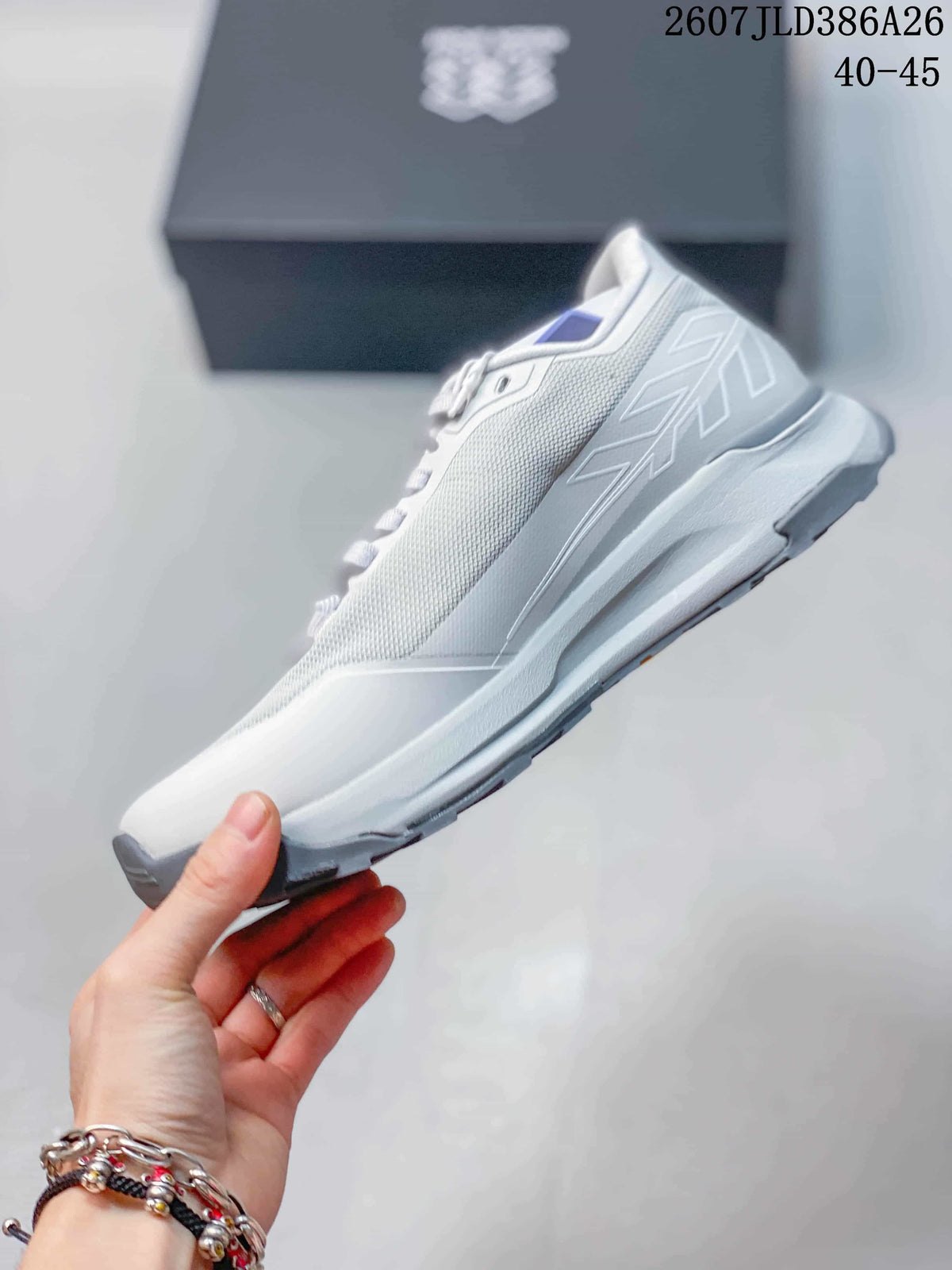 Side profile of the sneaker showing the textured upper, layered side panels, sculpted midsole, and rugged outsole.