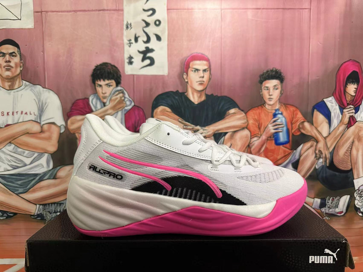 Side view of a white PUMA All-Pro shoe with black and pink graphics.