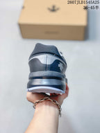 Rear view of the gray and black sneaker showing the padded heel collar, layered sole, and DESCENTE branding.