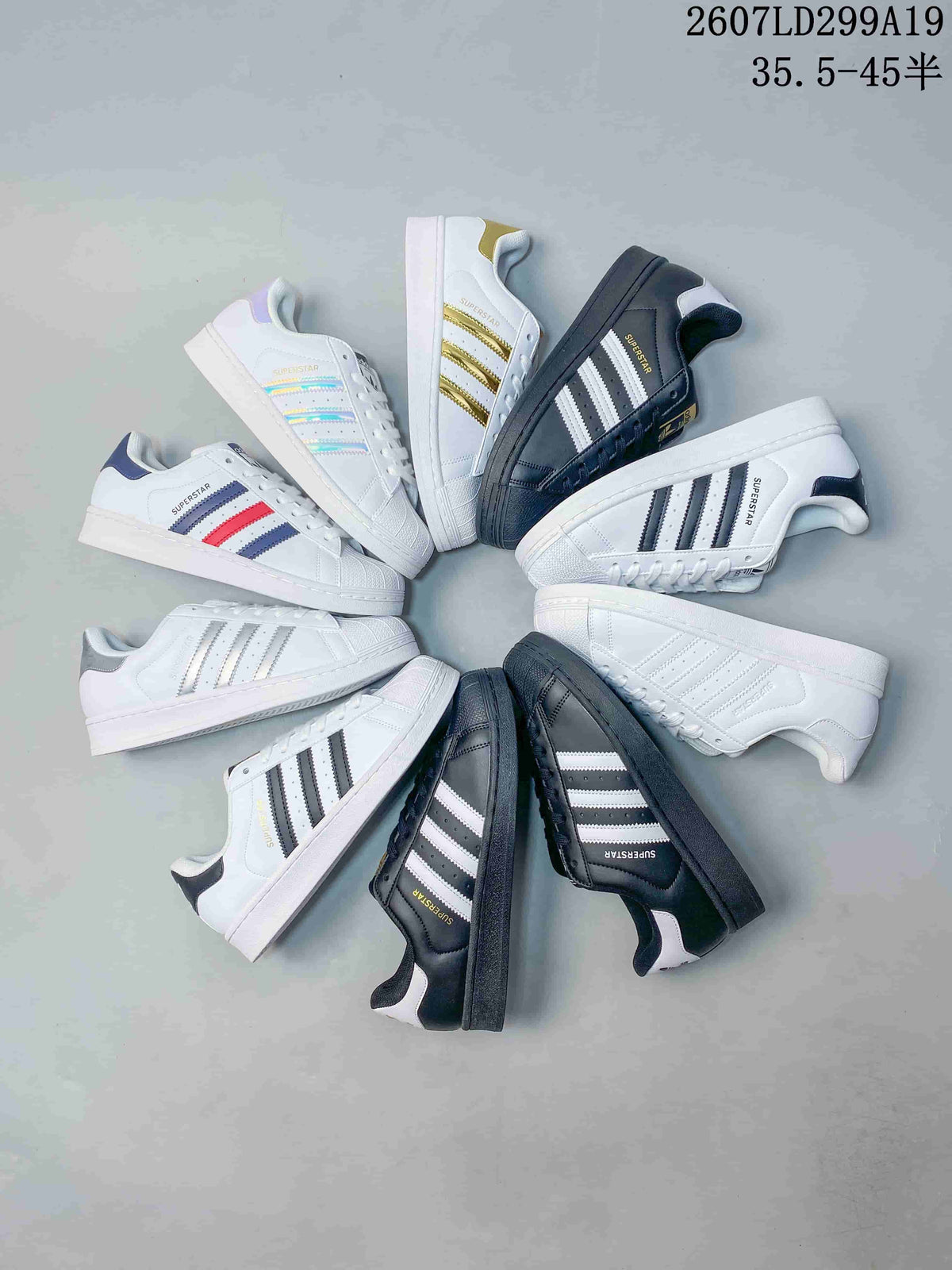 Flat-lay showing multiple adidas Superstar colorways with shell toes and contrasting stripes.