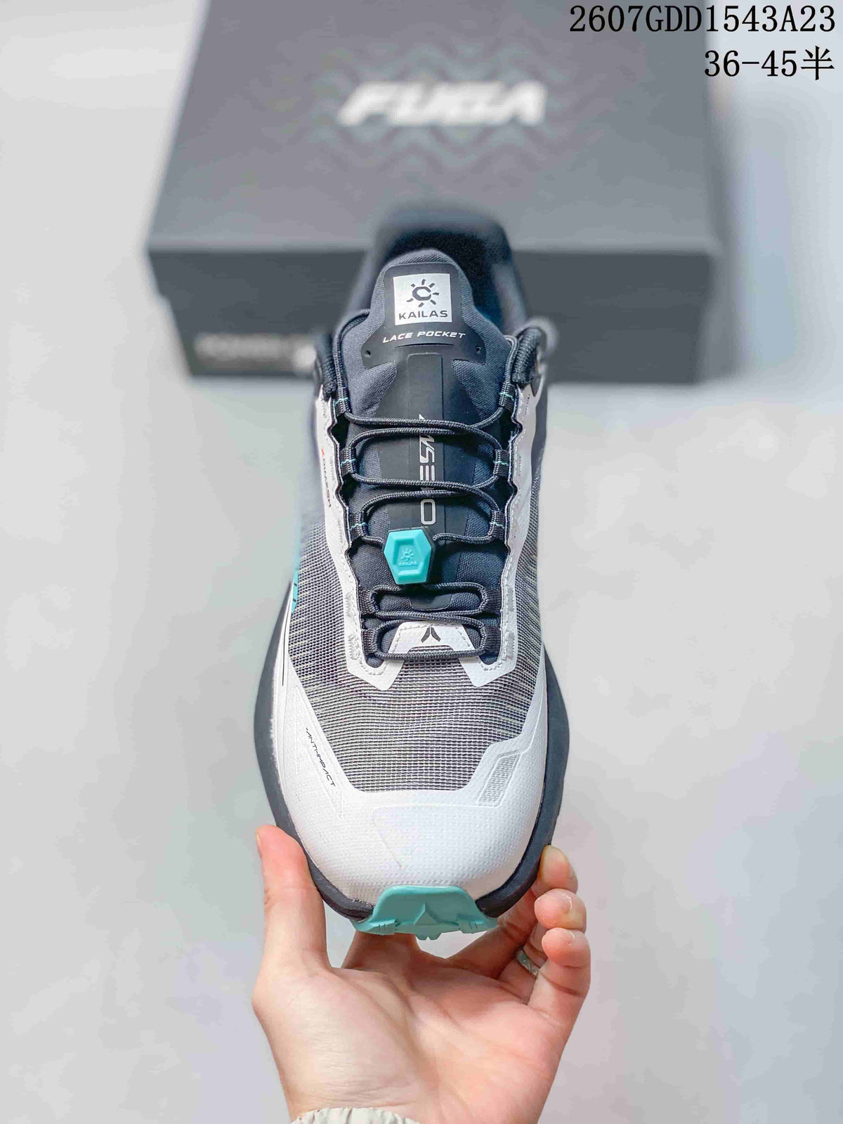 Top view of the shoe showing the structured mesh toe, lace pocket and teal quick-lock component.