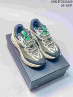 Pair of KAILAS low-top hiking shoes in green, navy and white displayed on a shoe box.