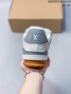 Rear view of the sneaker showing the gray heel panel, Louis Vuitton emblem, embossed side detailing, white midsole, and gum outsole.