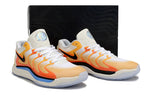 Pair of Nike KD 17 shoes in white with orange and yellow accents.