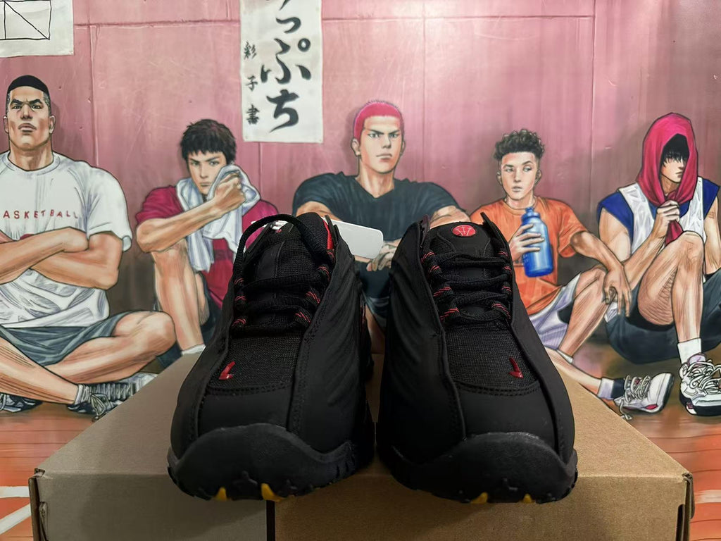 Front view of black Nike Shox sneakers with red accents