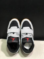 Top view showing white laces, forefoot straps, black toe panels, and red tongue branding.