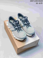 Gray On Cloud X4 sneakers with black laces shown on a shoe box; source text displays style code 2607JJD210A20 and size range 36–45.5.