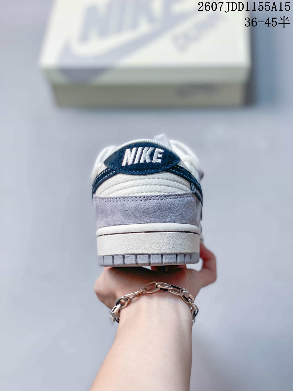 Rear view showing the gray heel overlay, white padded collar, navy accents, and Nike branding.