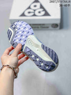Outsole view of a Nike ACG Pegasus Trail sneaker showing the patterned lugged tread and cream midsole.
