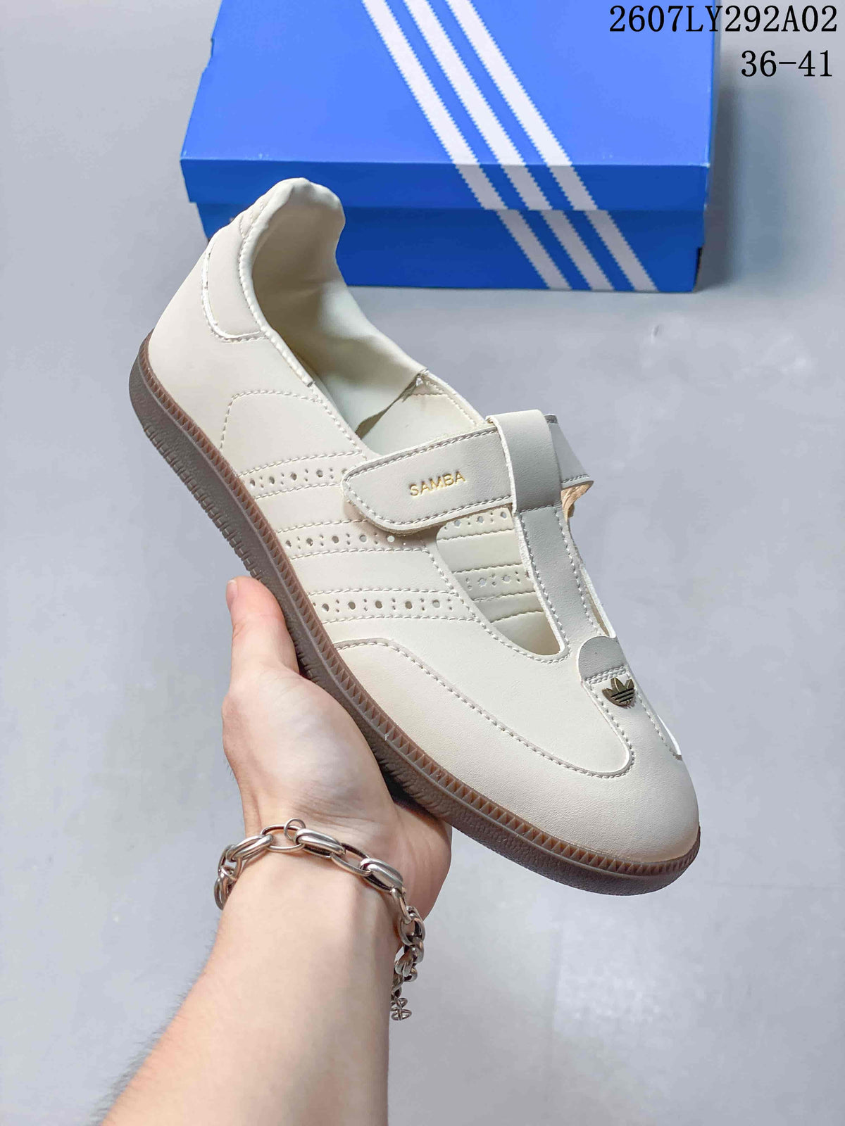 Close-up side view of the off-white Samba Jane sneaker showing the strap, perforated side panels and textured outsole.