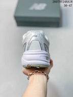 Rear view of the white and silver sneaker showing the padded heel and layered sole.