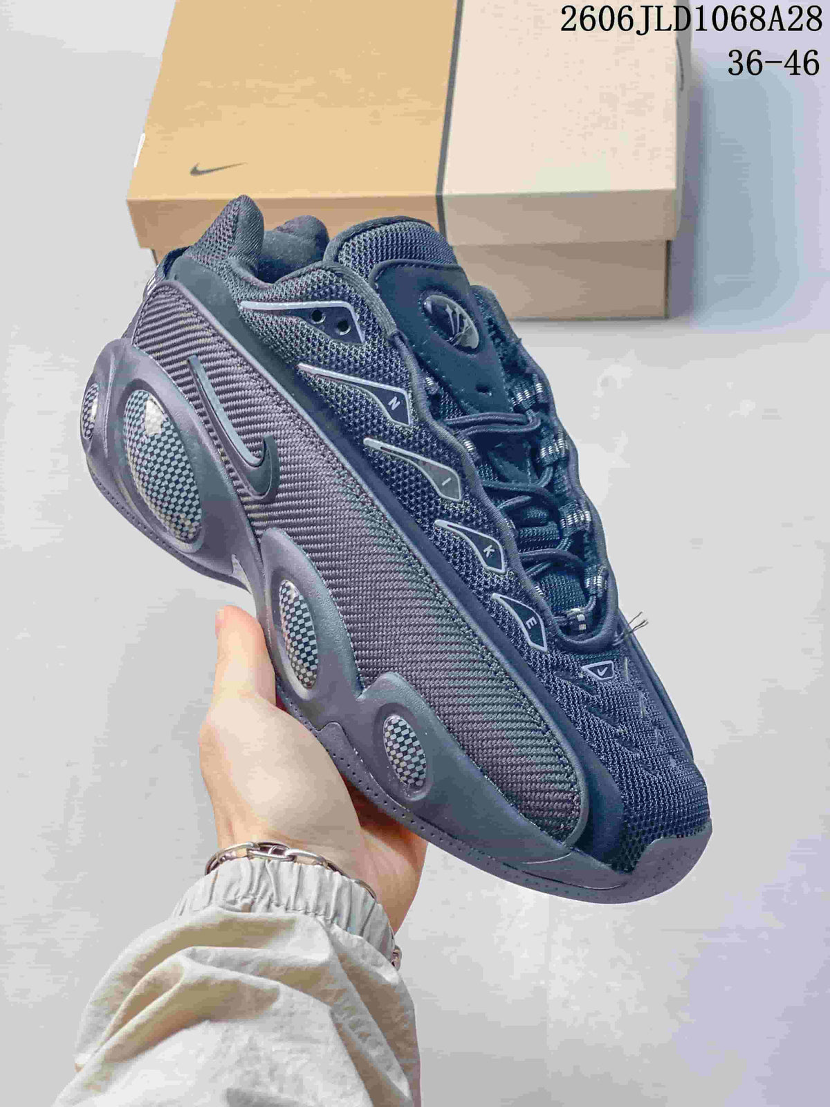 Angled side view of the dark sneaker with contrasting accents.
