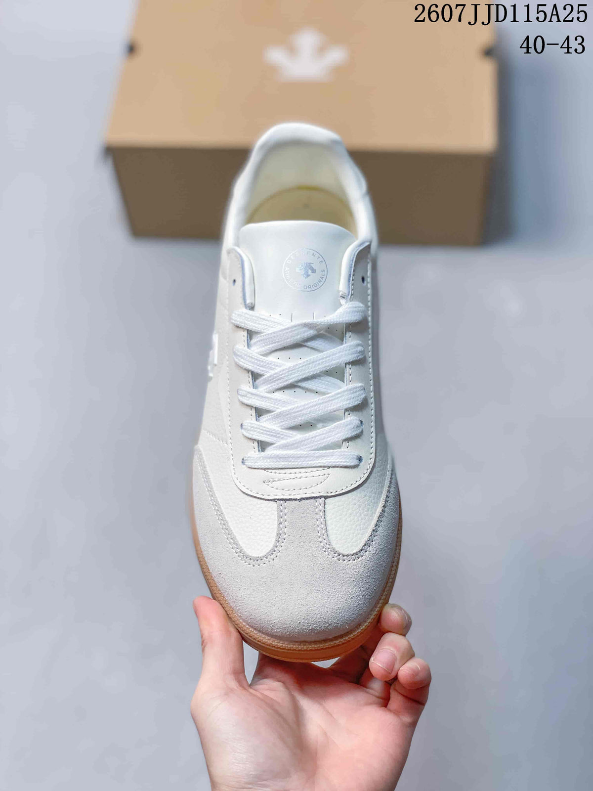 Top view of one sneaker showing the white laces, layered toe panels, and round tongue emblem.