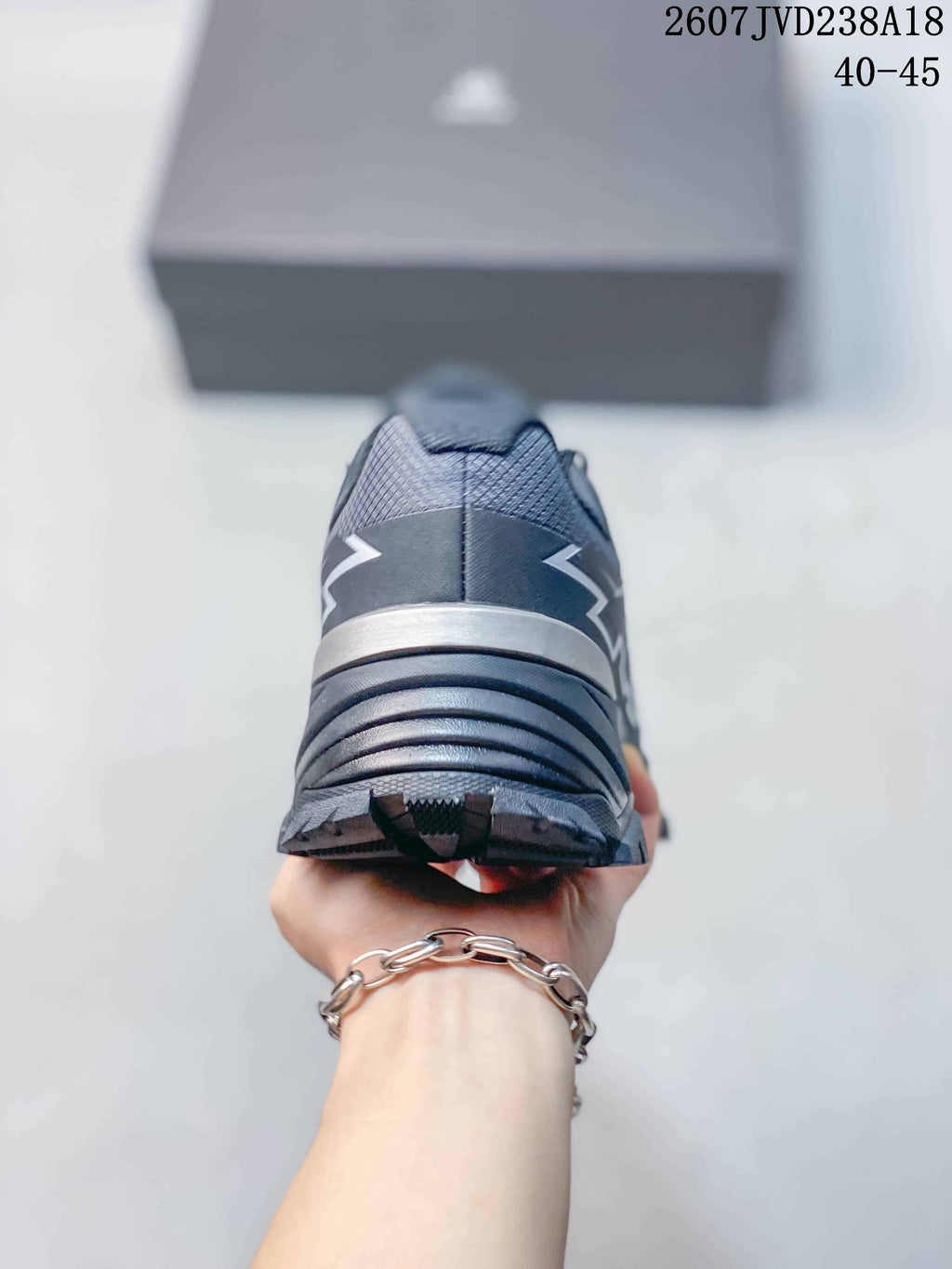 Rear view of the dark gray hiking shoe showing the padded heel, layered heel structure, and tread edge.