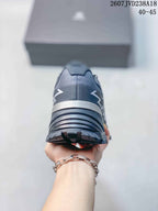 Rear view of the dark gray hiking shoe showing the padded heel, layered heel structure, and tread edge.