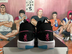 Rear view of black Nike GT Cut 3 shoes with pink details and blue outsole accents