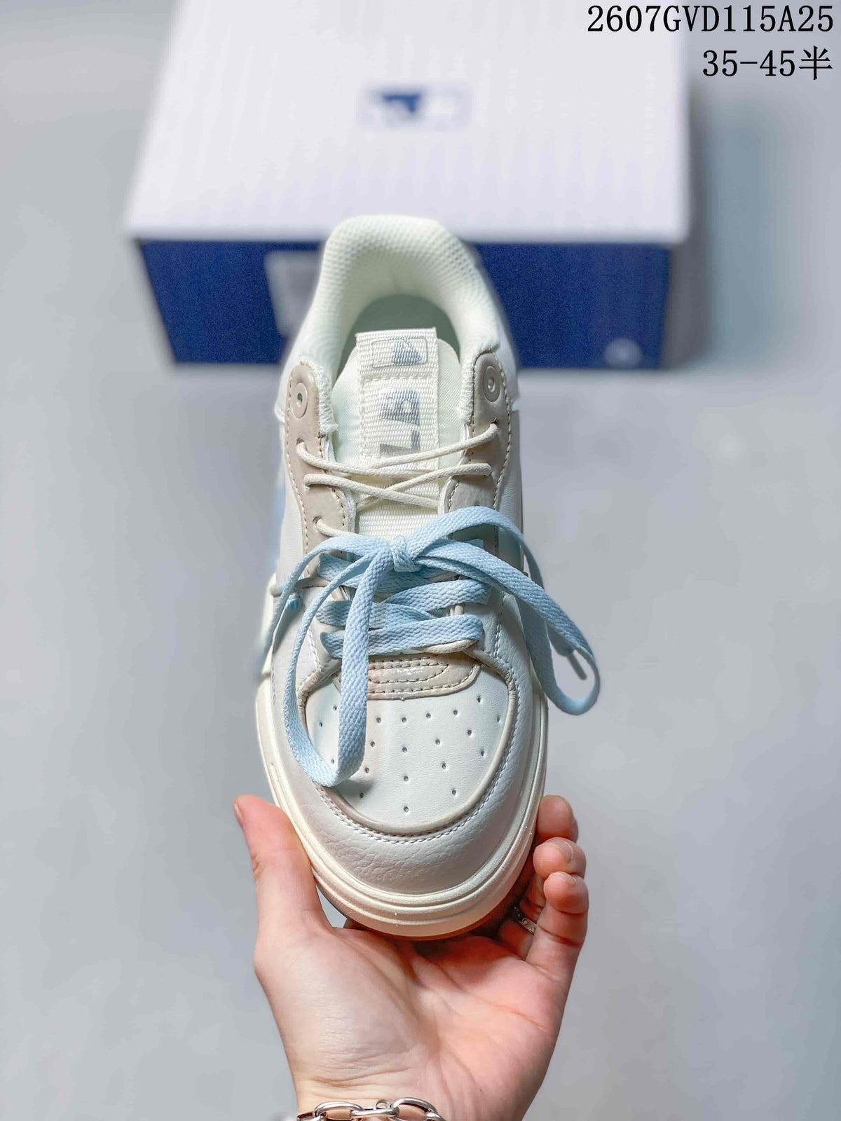 Top view of the sneaker showing the perforated toe box, neutral laces, and light blue replacement-style laces.