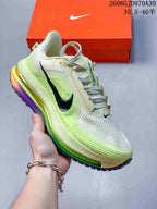Off-white and lime Nike Air Zoom Pegasus Premium sneaker with black side Swoosh and multicolor midsole accents.
