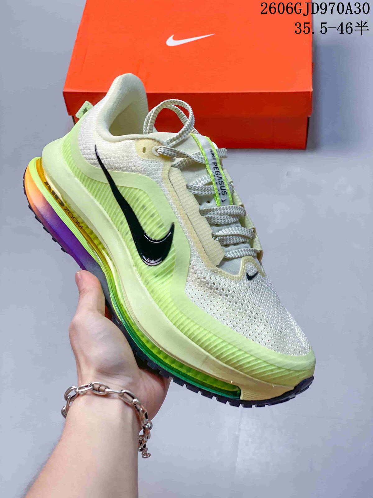 Off-white and lime Nike Air Zoom Pegasus Premium sneaker with black side Swoosh and multicolor midsole accents.