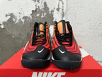 Front view of orange gradient Nike basketball shoes with black laces and toe panels