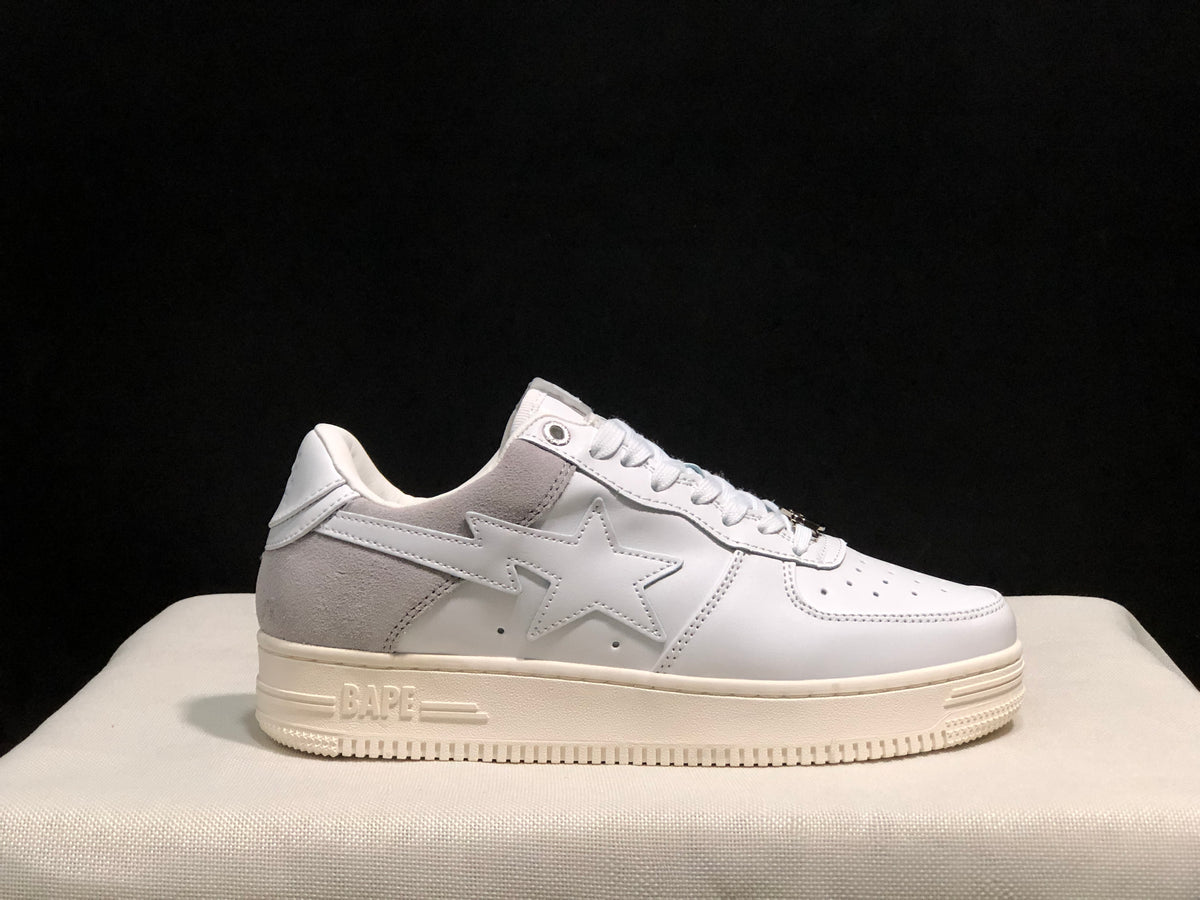 Side profile emphasizing the gray heel panel, star detail, white upper, and molded rubber sole branding.