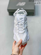 Top view showing the white mesh upper, lace-up front, tongue, and layered panel construction.