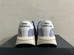 Rear view of New Balance U370 sneakers showing white heel panels and gray accents