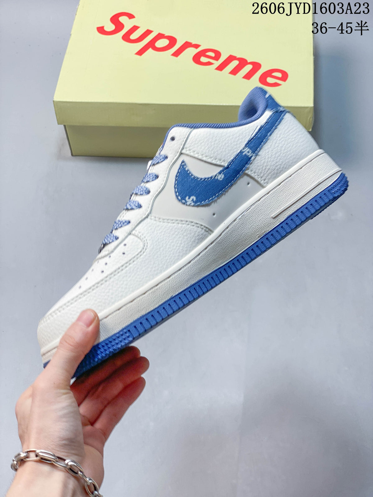 Side profile of the white and blue low-top sneaker
