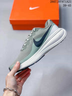 Side profile highlighting the navy Swoosh, textured upper, sculpted white midsole, and dark outsole.