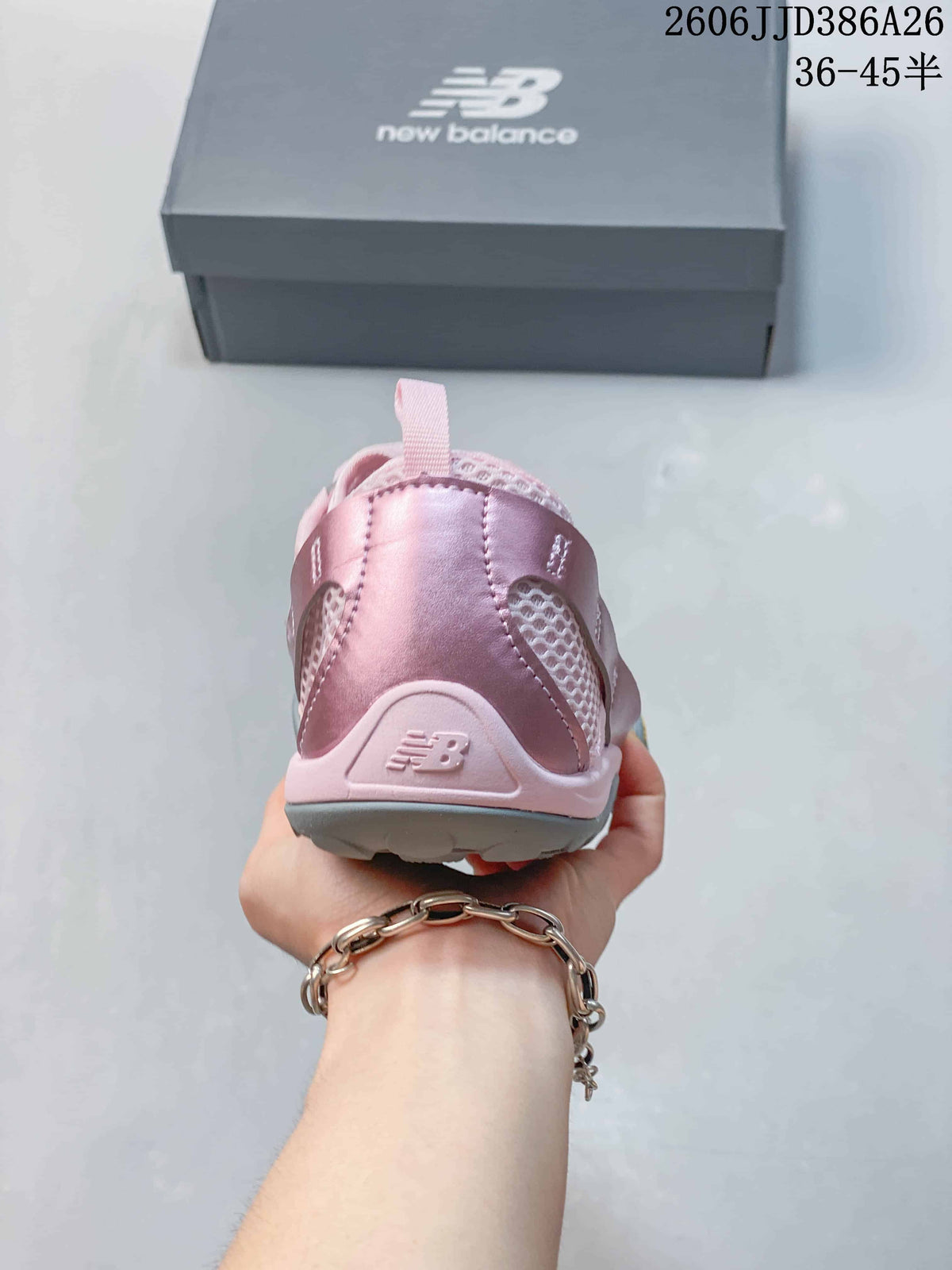 Rear view of the pink sneaker showing the padded heel, pull tab, and New Balance heel mark.