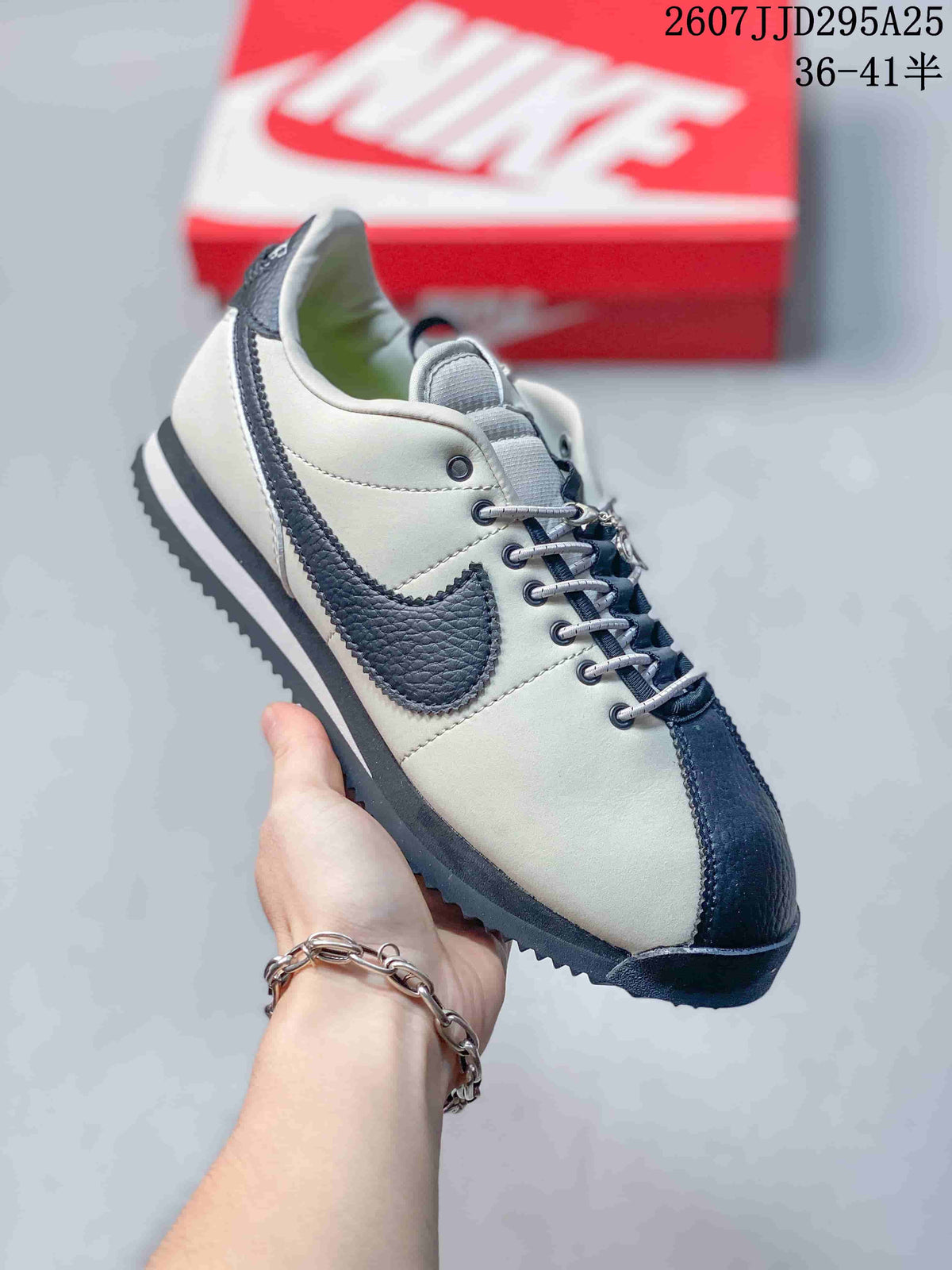 Angled side view showing the white upper, dark navy Swoosh and toe cap, and layered outsole.