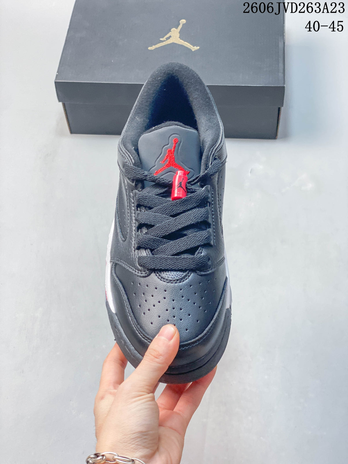 Front view showing the perforated toe, dark laces, and red tongue logo