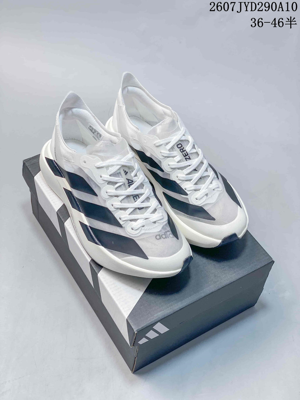 Pair of white Adidas Adizero Adios Pro Evo 2 shoes with dark blue and black accent panels.