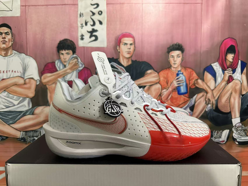 Side view of a white and red Nike basketball shoe showing perforated panels, a Swoosh, and ZoomX lettering.